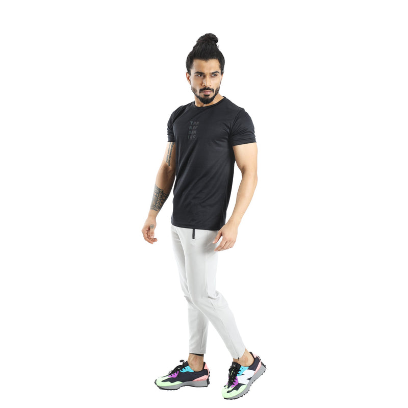 Men Wearing Black Holographic Tshirt and White Crop Pant.